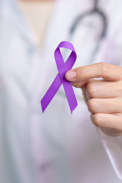 purple Ribbon for Violence, Pancreatic, Esophageal, Testicular cancer, Alzheimer, epilepsy, lupus, Sarcoidosis and Fibromyalgia. Awareness month and World cancer day concept - 写真・画像