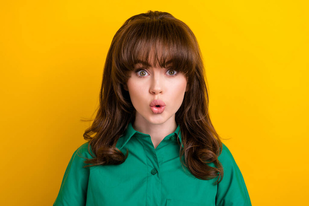Photo of shiny adorable impressed lady wear green shirt big eyes isolated yellow color background. - 写真・画像