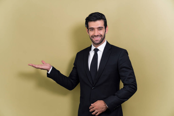 Confident businessman in formal suit making holding hand gesture to indicate promotion or advertising on empty space with excited facial expression and gesture on isolated background. Fervent - Photo, Image