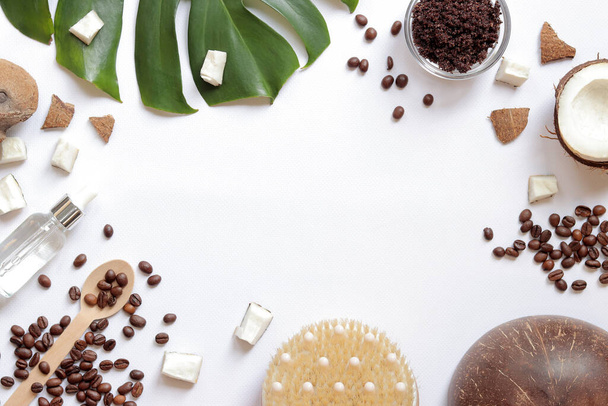 Spa self care concept. Flat lay composition of homemade coffee scrub ingredients on white background with empty space in the center, top view. Items for spa treatments - Foto, imagen