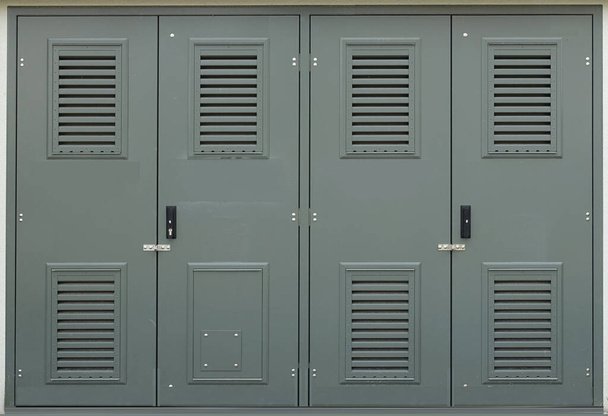 Doors of modern electrical panel gray wall texture. Construction. - Photo, Image
