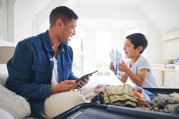 Plane ticket, luggage and father with excited family and holiday suitcase with dad and son. Home, bag and helping in a bedroom for vacation and packing with papa and boy kid together with a smile. - Фото, зображення