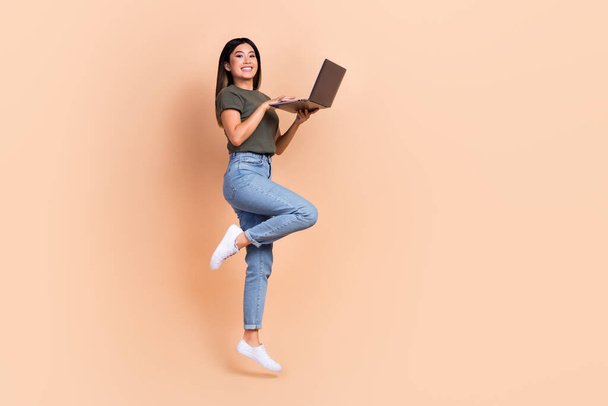 Full body photo of young model vietnamese woman programmer it specialist jump team lead project worker isolated on beige color background. - Photo, Image
