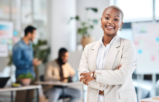 Portrait, smile and black woman in modern office with arms crossed, leadership and startup business. Professional management, happiness and confident African businesswoman in corporate work space - Foto, imagen