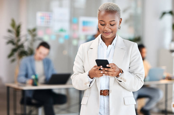 Phone, business and black woman typing, happy and social media in company. Smartphone, networking and African professional reading email, message and news on internet, app or texting online in office. - Foto, imagen