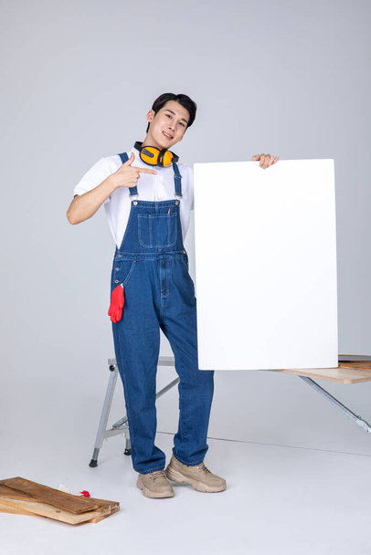 millennials and gen z, korean asian young man carpenter with a frame panel - Photo, Image