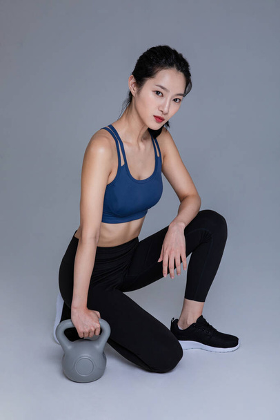 healthy beauty concept photo of korean asian beautiful woman with kettlebell - Foto, imagen