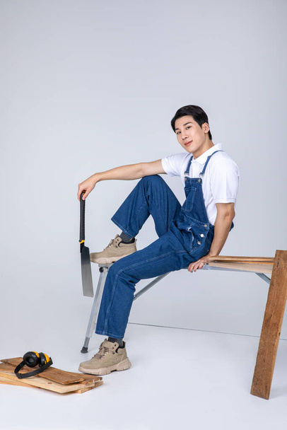 millennials and gen z, korean asian young man carpenter holding tablet pc - Photo, Image