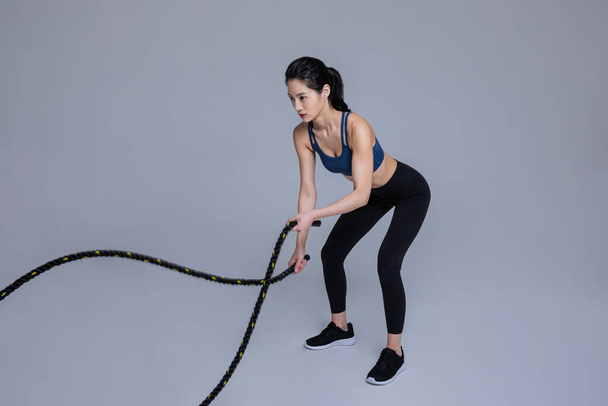 healthy beauty concept photo of korean asian beautiful woman with battling ropes - Φωτογραφία, εικόνα