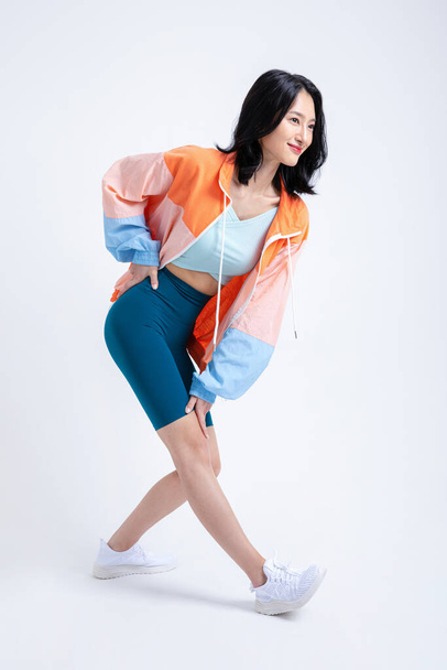 healthy beauty concept photo of korean asian beautiful woman stretching with jacket - Фото, зображення