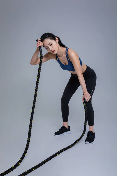 healthy beauty concept photo of korean asian beautiful woman with battling ropes - Фото, зображення
