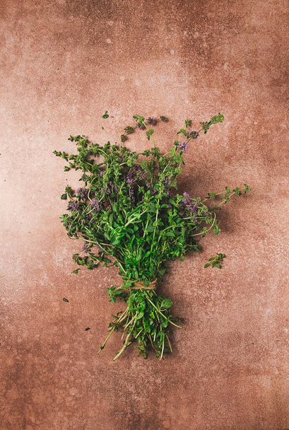 bouquet of herb ombalo, marsh mint, bunch of mint, top view, on a brown background, spice, Georgian cuisine, - Valokuva, kuva