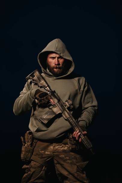 Portrait of Ukrainian defender holding rifle  - Fotoğraf, Görsel