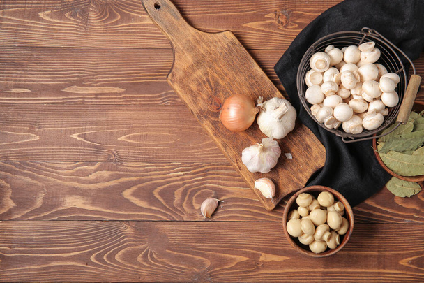 Canned and fresh mushrooms with ingredients for preservation on wooden background - Photo, Image