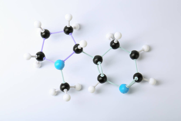 Molecule of nicotine on white background, top view. Chemical model - Fotografie, Obrázek