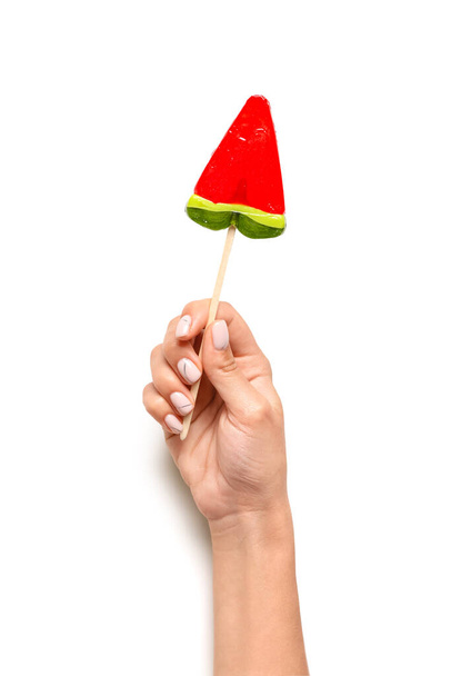 Woman holding lollipop in shape of watermelon slice on white background - Photo, Image