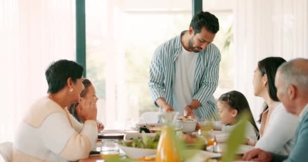 Thanksgiving, food and a father serving his family while eating food for bonding in celebration. Love, lunch or brunch with a man carrying a dish to the dining room table during a holiday event. - 映像、動画
