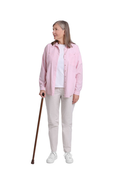 Senior woman with walking cane on white background - Фото, изображение