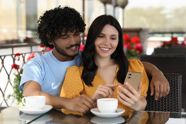 International dating. Happy couple spending time together in restaurant - Photo, image