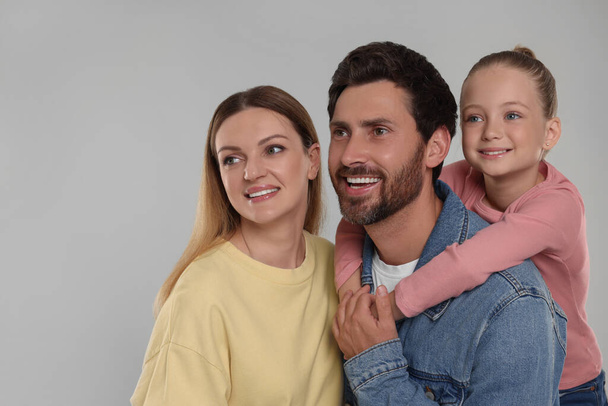 Happy family on light grey background, space for text - Valokuva, kuva