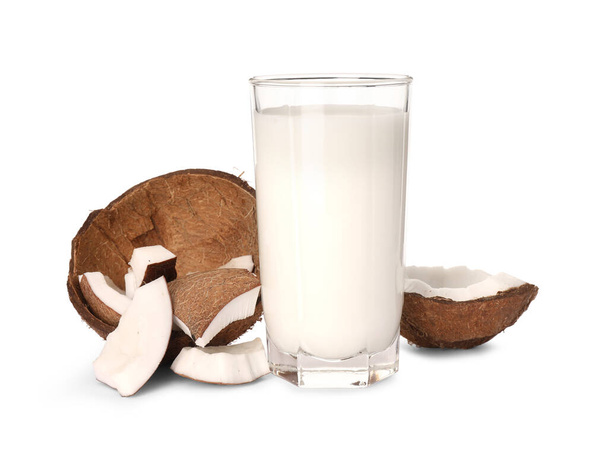 Glass of delicious vegan milk and coconut pieces on white background - Valokuva, kuva