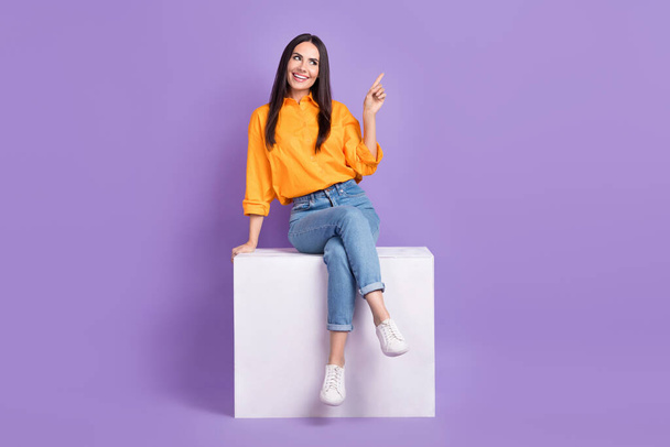 Full length body photo of positive girl direct finger useful tips empty space website button click buy isolated on violet color background. - Fotografie, Obrázek