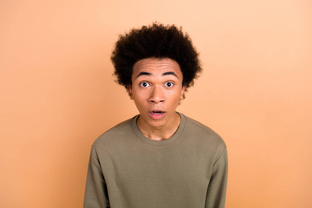 Portrait of impressed speechless young person open mouth staring cant believe isolated on beige color background. - 写真・画像