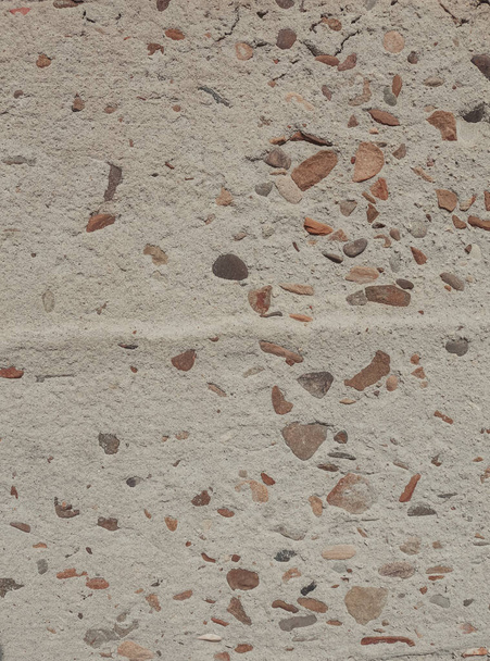 Fragment of an old wall with damages and little rocks. Grunge texture close up. Stone beige background. Easily add depth and organic texture to your designs. - Valokuva, kuva
