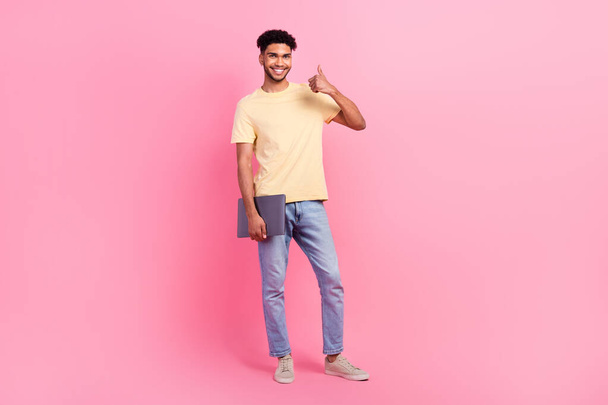 Full body photo of young cheerful man wear yellow t-shirt it specialist recommend courses online with laptop isolated on pink background. - Fotó, kép