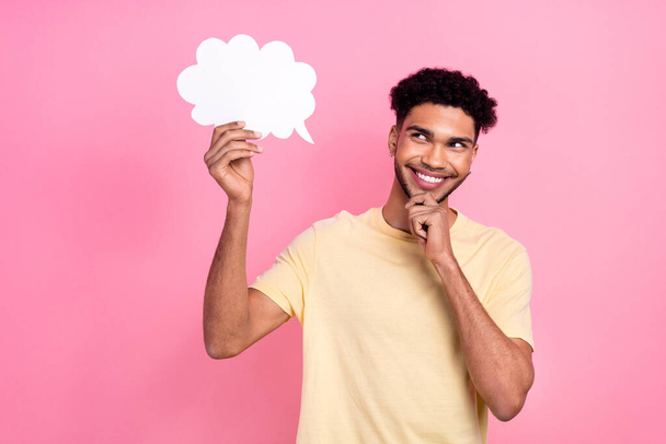 Portrait of funny cunning tricky man wear stylish t-shirt look at mind cloud empty space hand on chin isolated on pink color background. - 写真・画像