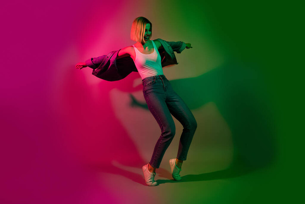Full size photo of crazy youngster lady enjoy dancing futuristic weekend night club isolated on gradient vibrant neon color background. - Φωτογραφία, εικόνα