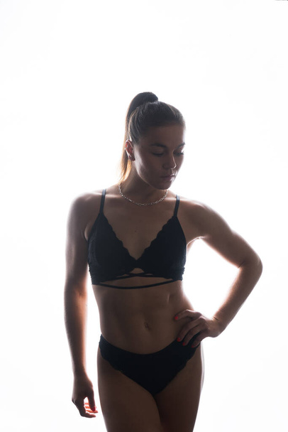 Female silhouette in a lingerie. Young slim seductive woman with sport fitness body - Φωτογραφία, εικόνα