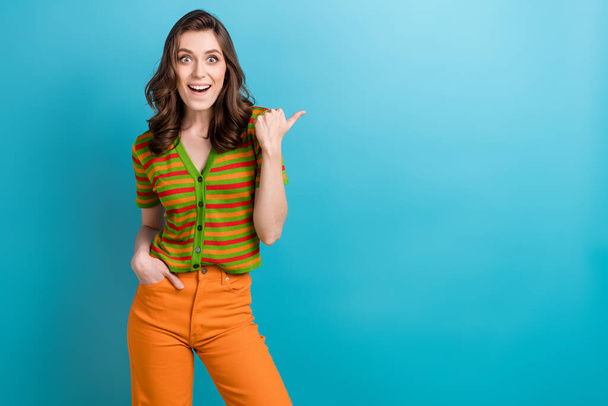 Photo of crazy funky model brown hair girl showing finger direct finger mockup speechless presentation isolated on blue color background. - 写真・画像