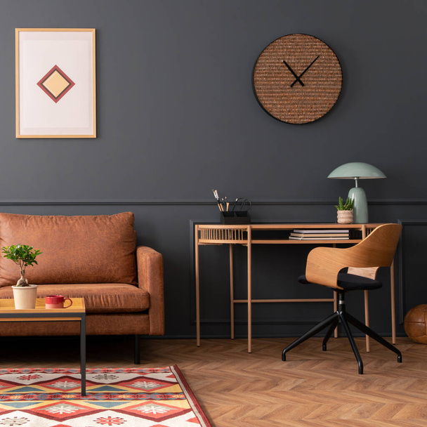 Creative composition of living room interior with mock up poster frame, brown sofa, wooden desk, coffee table, clock, flower in flowerpot, patterned rug and personal accessories. Home decor. Template. - Foto, Imagen