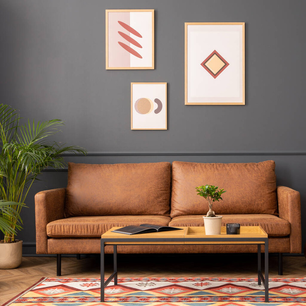 Modern living room interior with mock up poster frame, brown sofa, wooden coffee table, patterned rug,  round clock, plants, beige curtain, desk and personal accessories. Home decor. Template.  - Foto, afbeelding