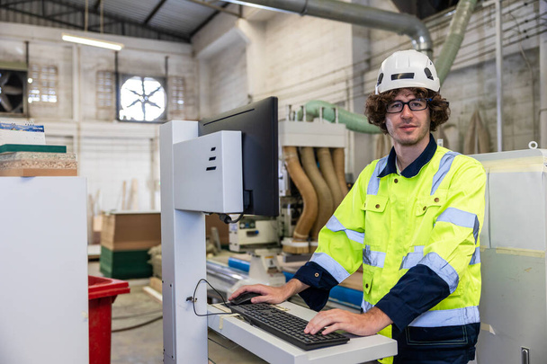 young caucasian engineer technician male staff worker portrait smiling in modern industry furniture factory - Fotoğraf, Görsel