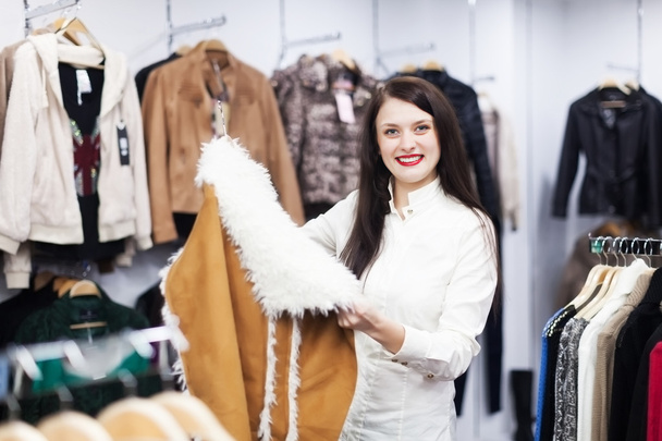 Girl choosing jacket at boutique - Foto, imagen