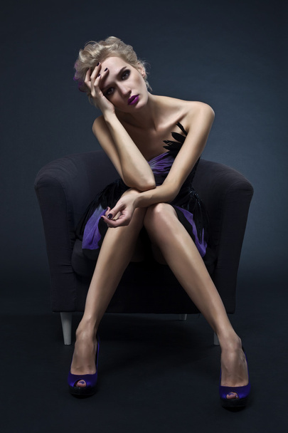 The image of a beautiful luxurious woman sitting on chair. Studi - Zdjęcie, obraz