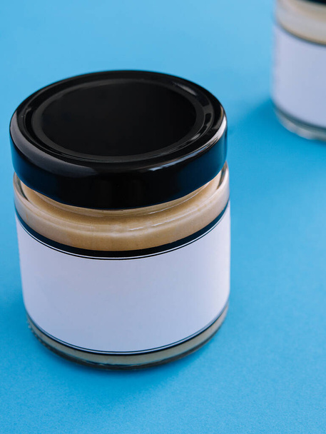Peanut, almond, nut butter in glass jar - Photo, image