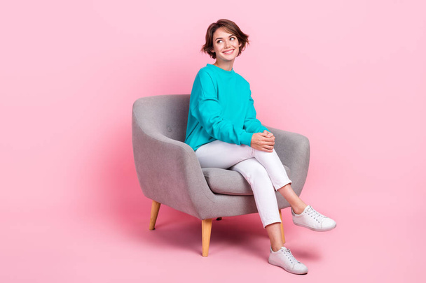 Full length photo of adorable gorgeous lady sitting cozy chair looking empty space seasonal offer sale isolated on pink color background. - Fotó, kép