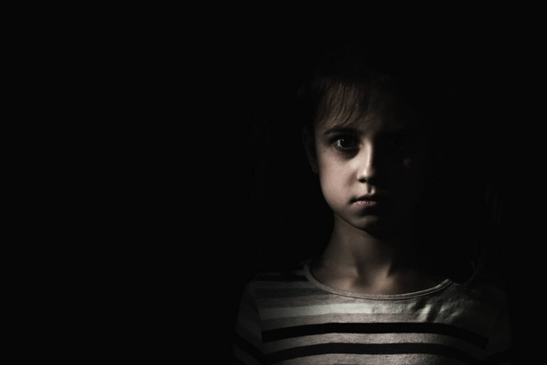 Conceptual image: psychological injuries, children's anxieties and fears, lost childhood. Sad unhappy little child girl feel lonely abandoned, children drama. Copy space. - Foto, Imagem