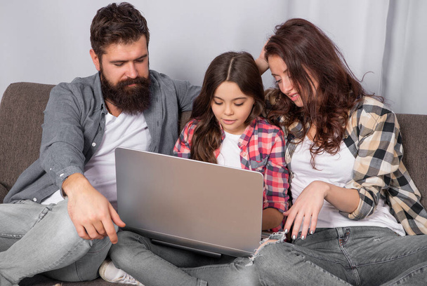 happy parents with kid girl elearning online. mom dad and daughter shopping on cyber monday. modern education and communication. video call. father mother and child use laptop. family blog. - Foto, imagen