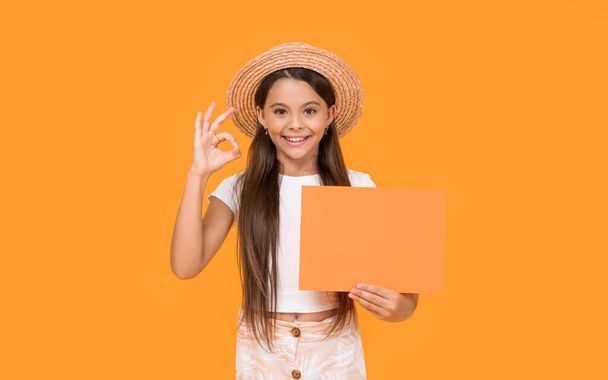 happy teen kid with copy space on orange paper on yellow background. - Photo, Image