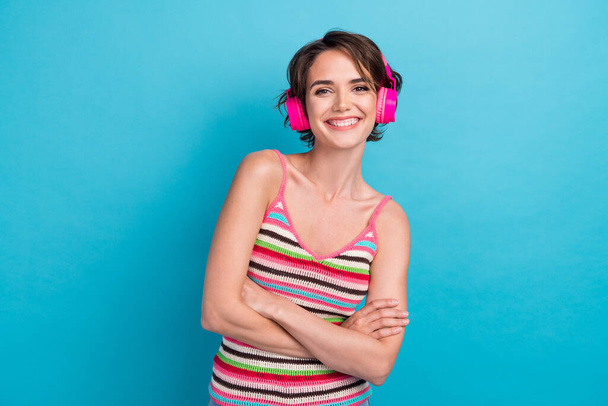 Portrait of cute cheerful person toothy smile crossed hands listen music headphones isolated on blue color background. - Φωτογραφία, εικόνα