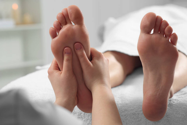 Woman receiving foot massage in spa salon, closeup - Foto, imagen