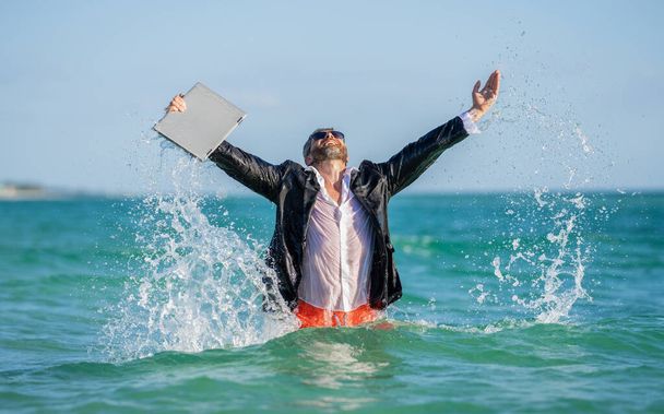 Businessman excited in sea water. Business man in wet suit in sea water. Crazy business vacation. successful businessman finally relaxing. businessman has success. successful business deal. - Foto, Bild