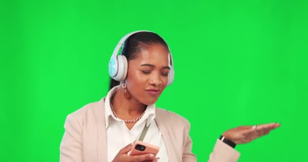 Business woman, headphones and phone on green screen for music, dancing and fun. Female model person with smartphone for listening to audio sound with fun energy, smile and motivation in studio. - Footage, Video