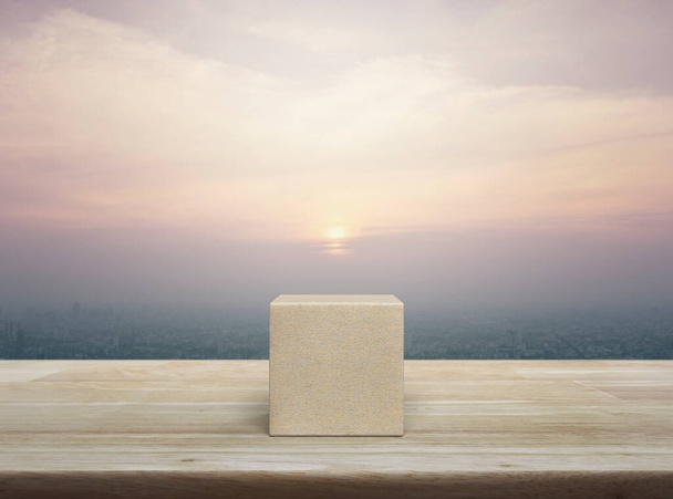 Wood block cube on wooden table over city tower and skyscraper at sunset, vintage style - Foto, immagini