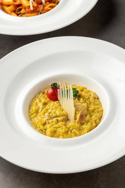 Parmesan cheese risotto on a white porcelain plate - Φωτογραφία, εικόνα