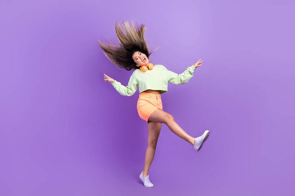 Full size photo of girlish good mood woman dressed green shirt stylish skirt fooling jumping have fun isolated on purple color background. - Fotoğraf, Görsel